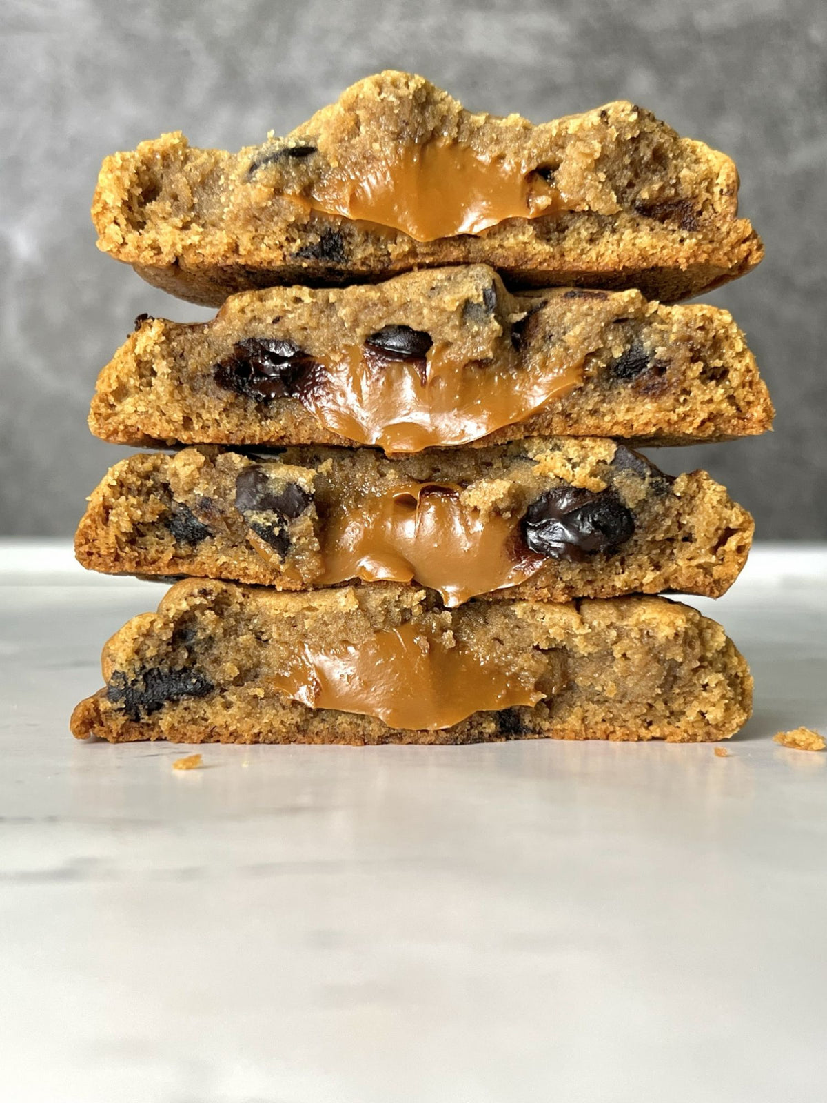 A stack of four Vietnamese Coffee cookies broken open, condensed milk filling running down the sides